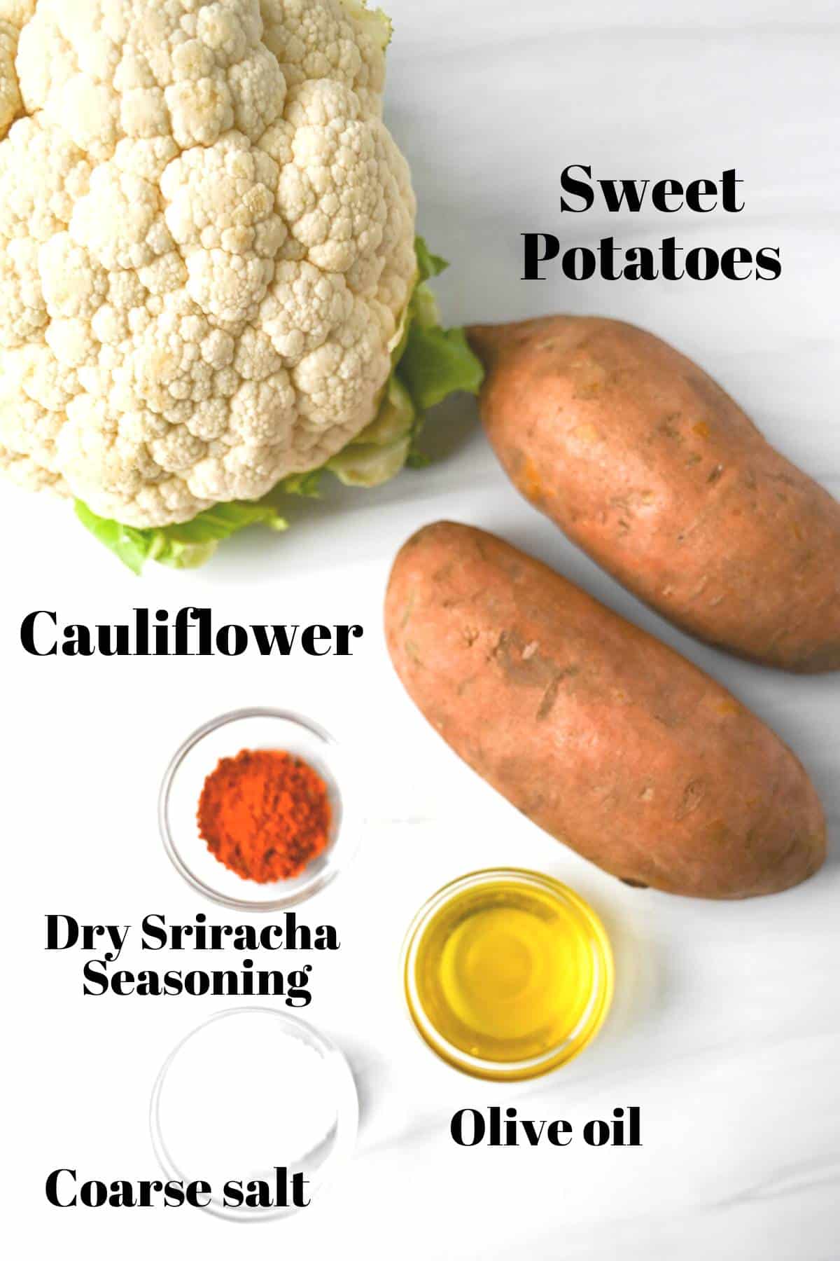 a head of cauliflower, 2 sweet potatoes, oil, sriracha seasoning, and salt on a counter