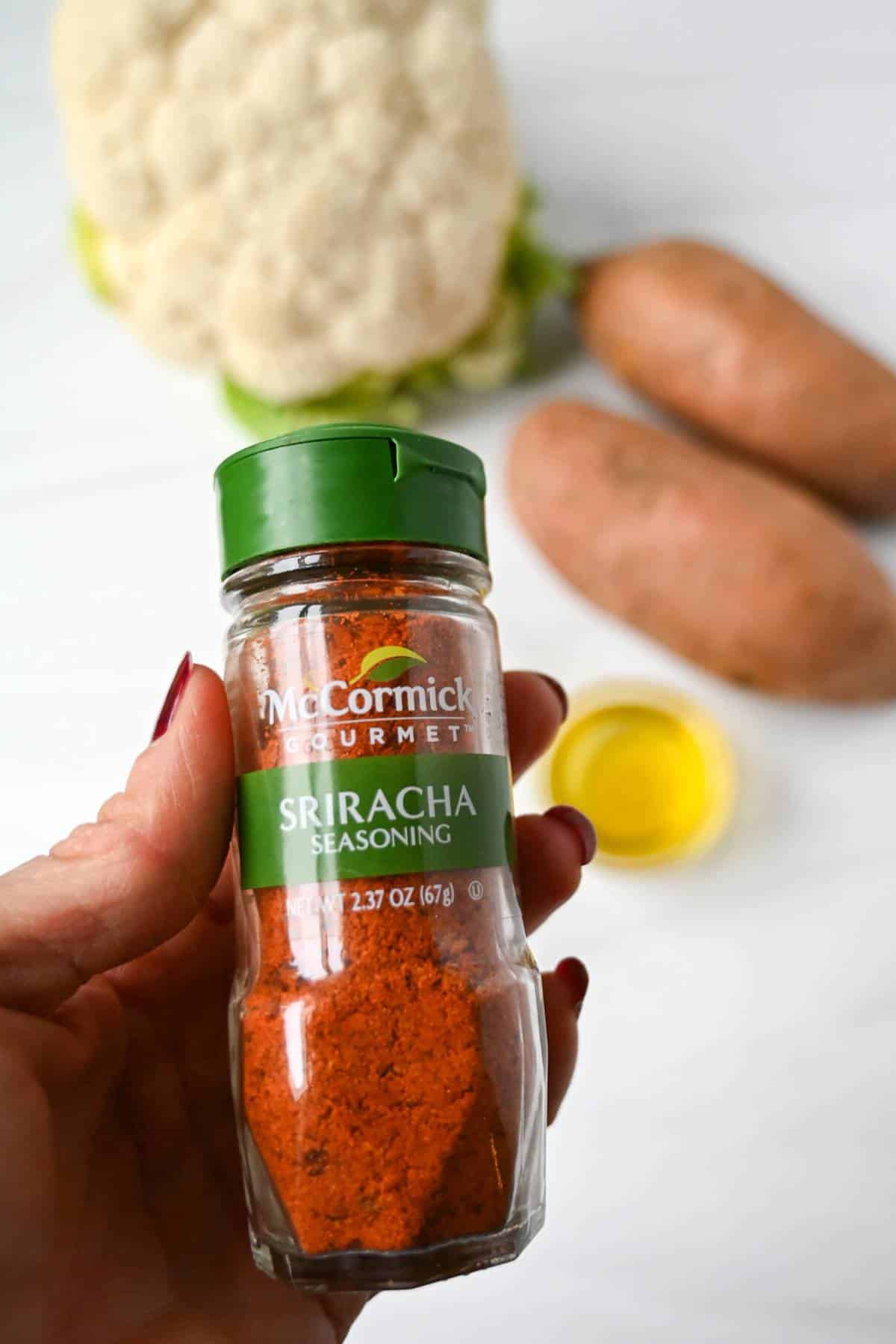 Sriracha seasoning  held over veggies