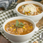 Bowls of chicken chili with a spoon