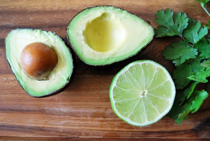 Ripe Avocado sliced in half on a cutting board