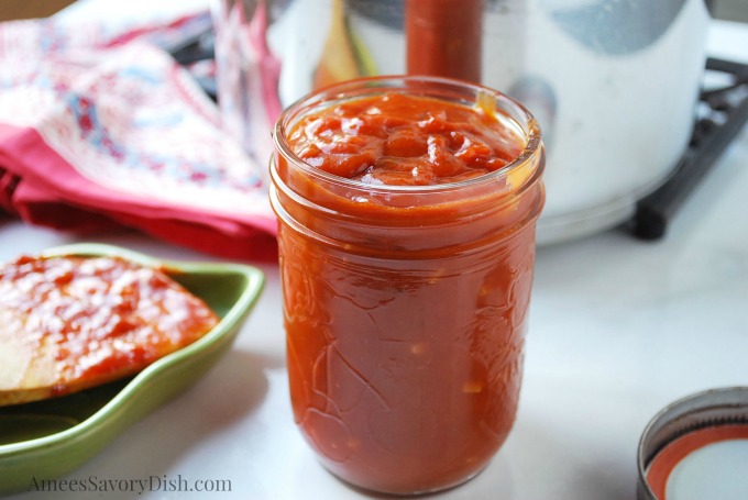 Barbecue sauce in a jar with a napkin in the background