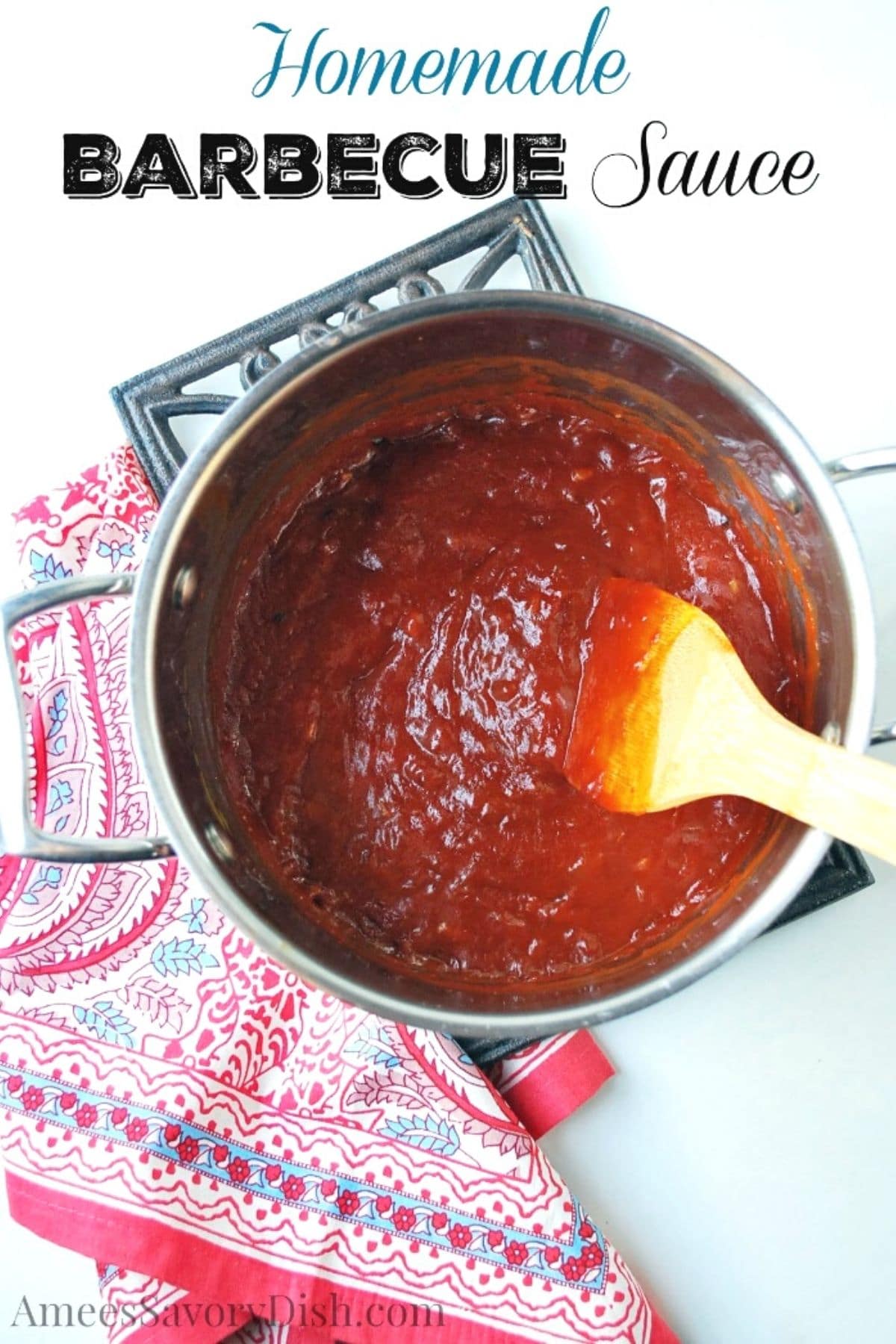 overhead photo of BBQ sauce in a sauce pan with a colorful napkin underneath