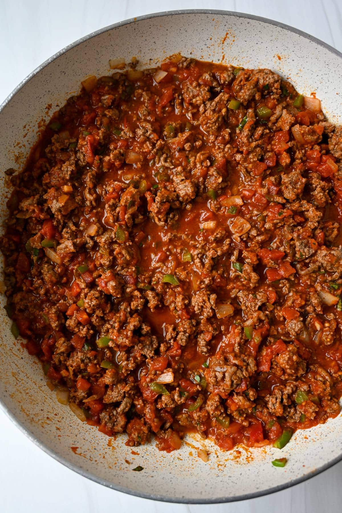 spaghetti sauce for southern spaghetti casserole simmering in a skillet