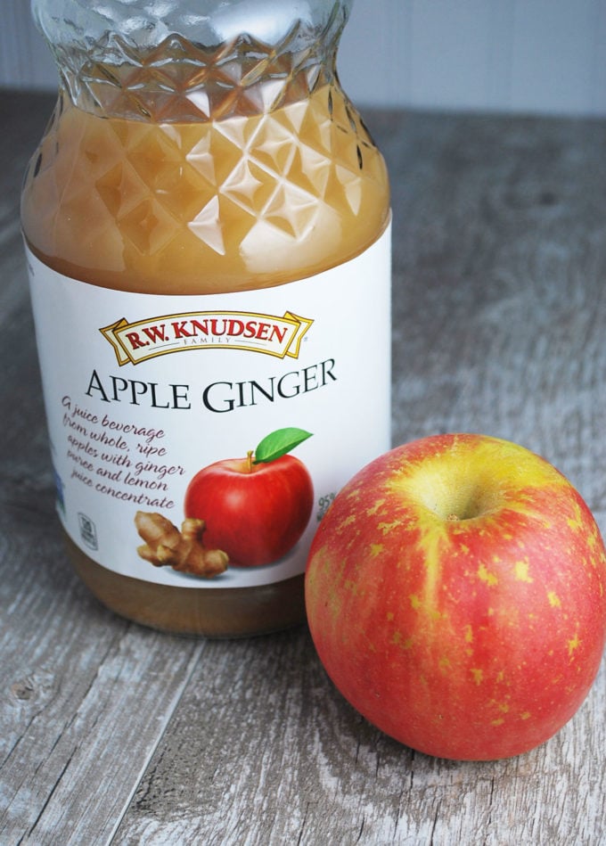apple ginger juice in a bottle next to an apple