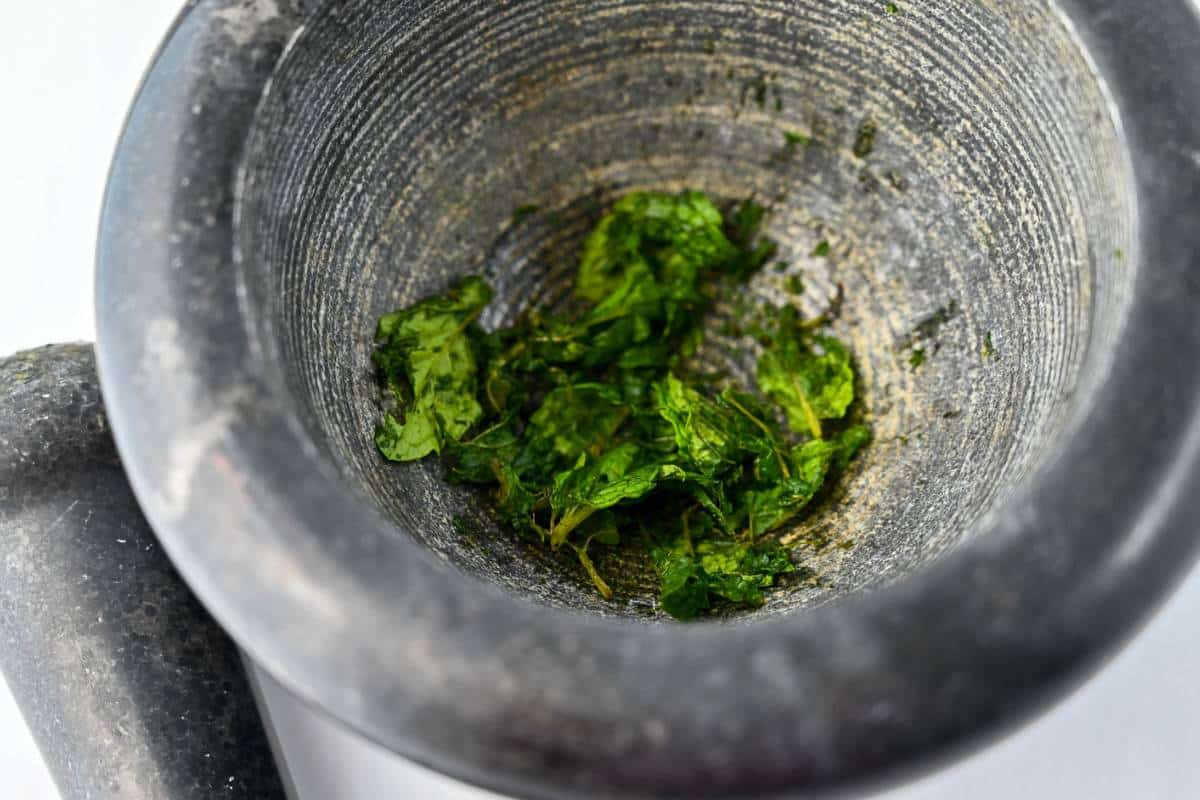 mint muddled in a mortar and pestle