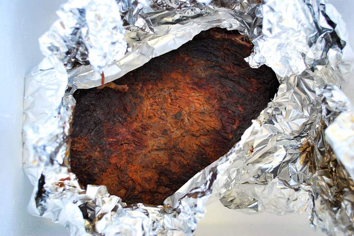 brisket wrapped in foil ready to rest