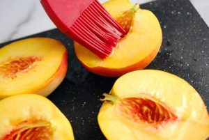 Sliced fresh peaches brushed with olive oil
