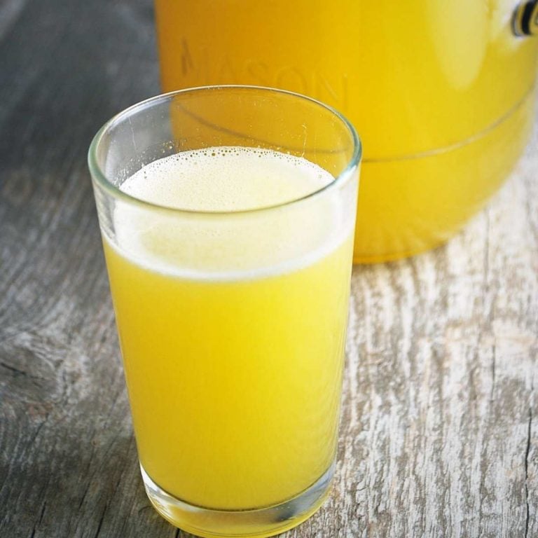 Homemade sports drink in a glass with a pitcher in the background