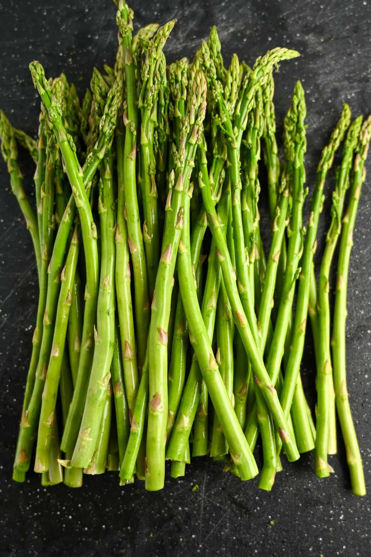 washed and trimmed asparagus on a cutting board