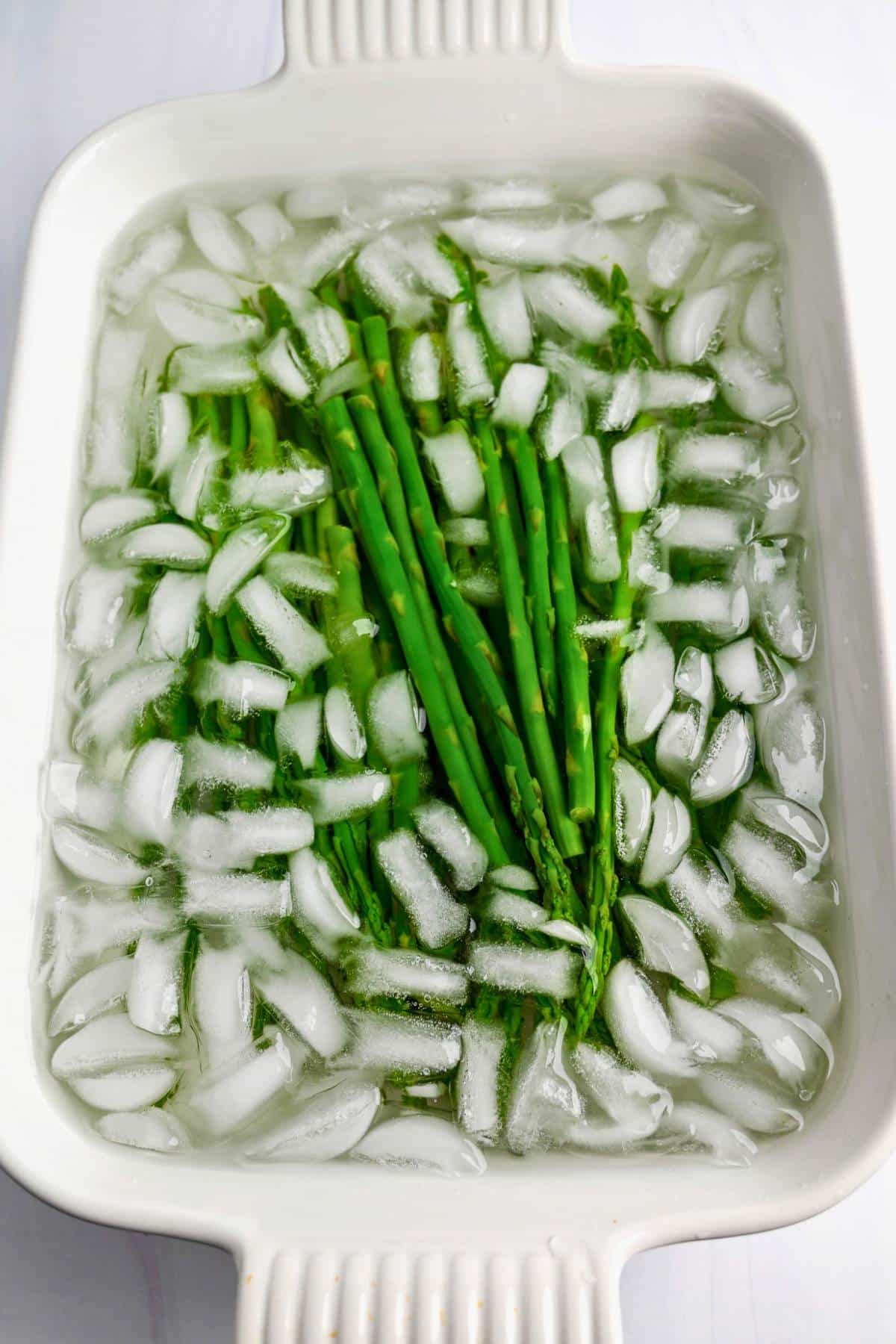 cooling cooked asparagus in an ice bath