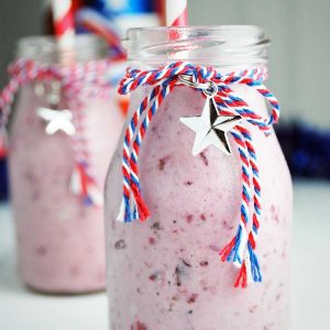 two cherry protein shakes in July 4th themed glasses