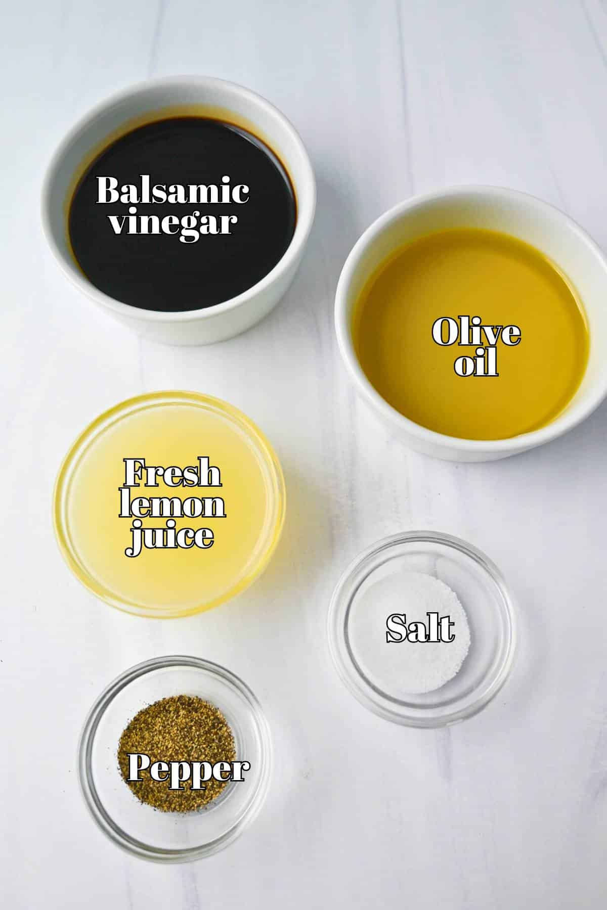 ingredients to make a lemon balsamic dressing measured out on a counter