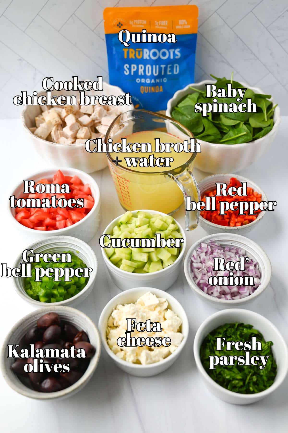 ingredients to make a quinoa bowl with cooked chicken on a counter