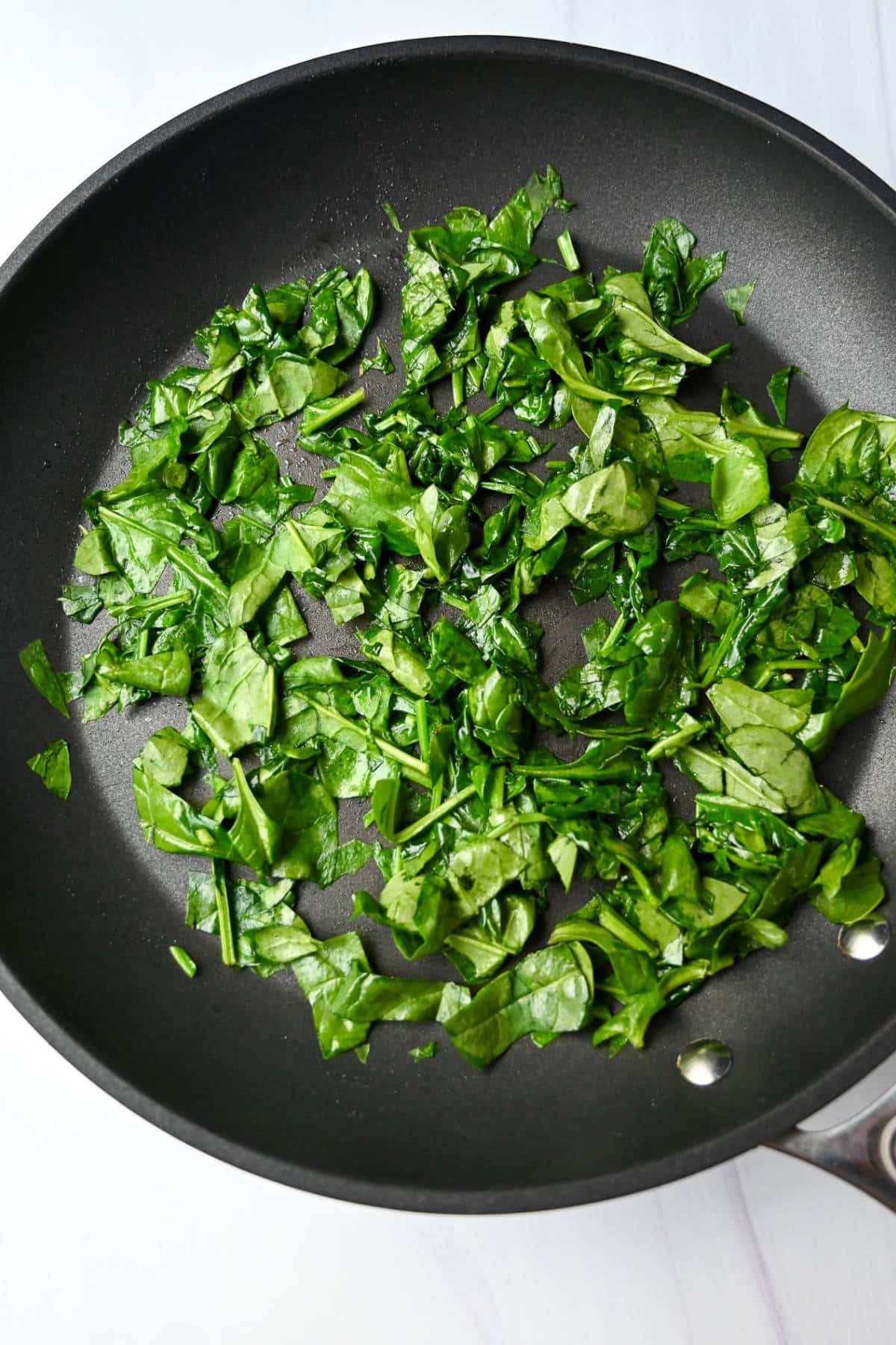 sauteed spinach in a skillet