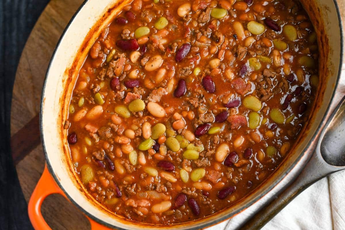 side view of a dutch oven of cowboy baked beans