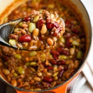 holding up a spoonful of baked beans