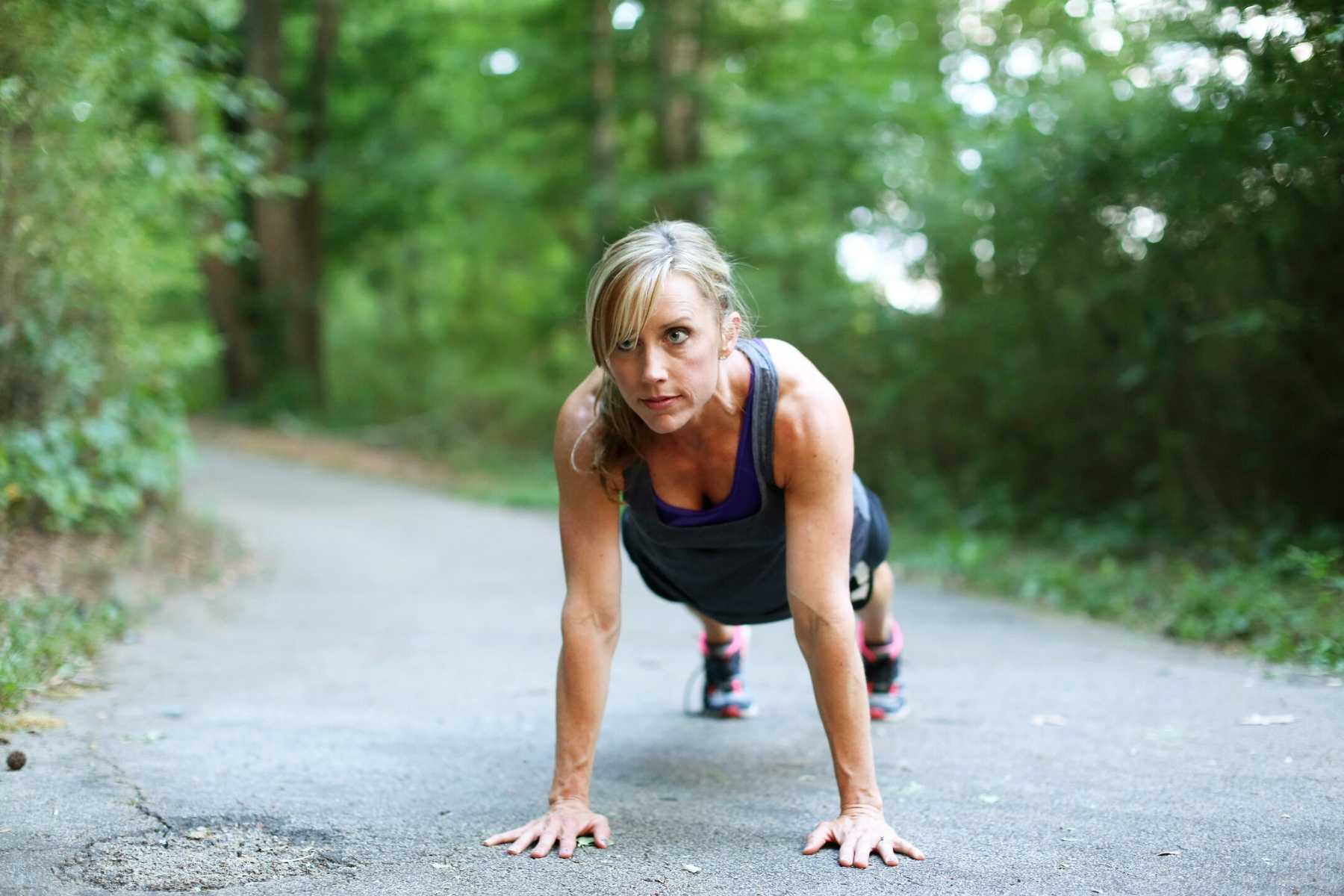 woman in a plank position on the ground