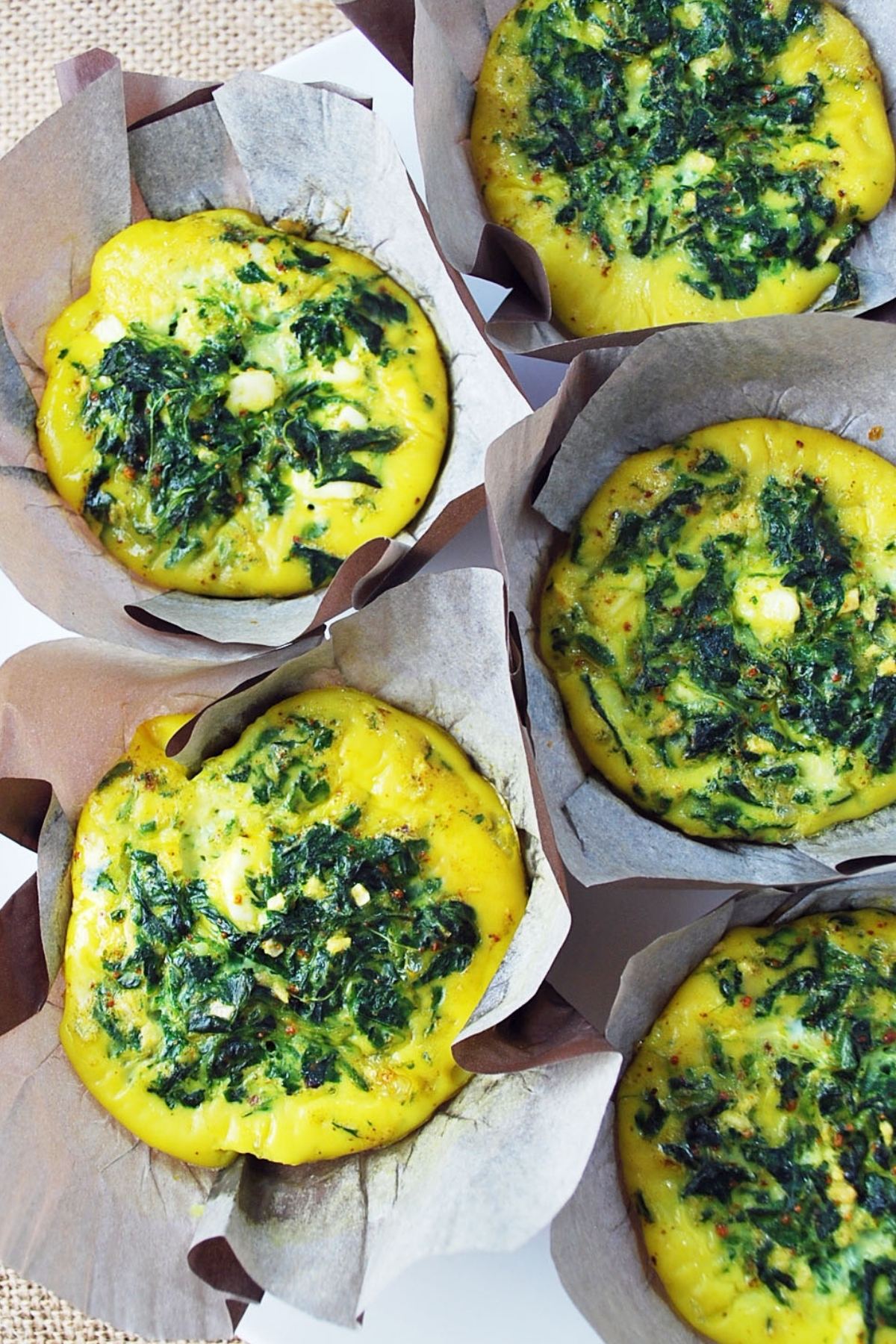 A quick and easy recipe for Spinach Frittata Muffins made with spinach, eggs, feta cheese, and ground turmeric. These delicious mini frittatas are perfect for breakfast on-the-go! via @Ameessavorydish