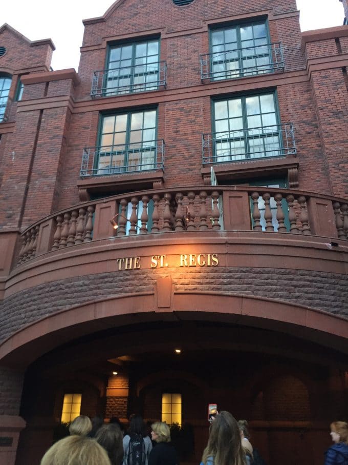 A group of people standing in front of a brick building