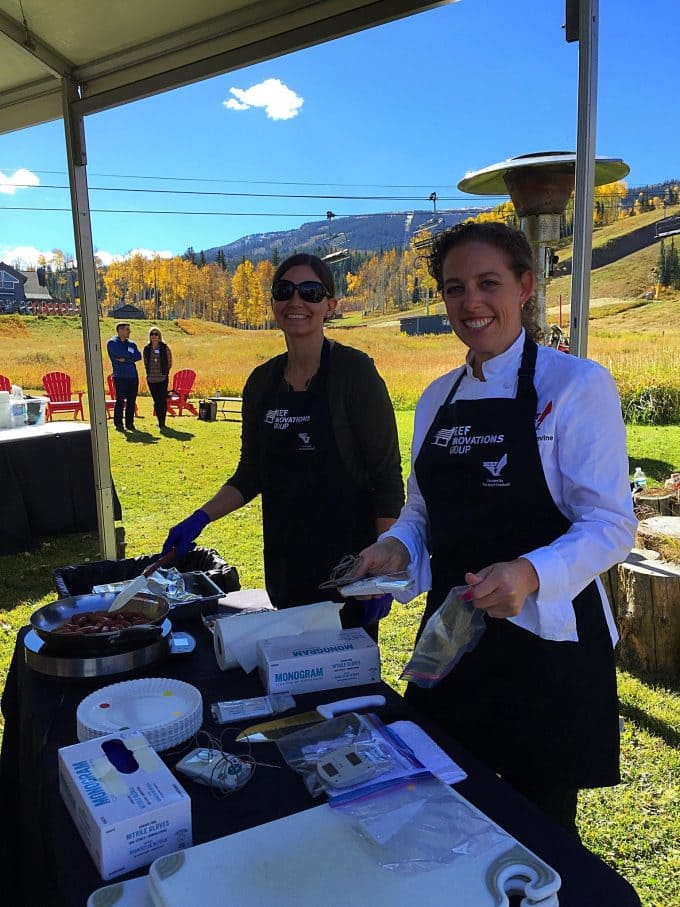 Chefs cooking outdoors under a canopy