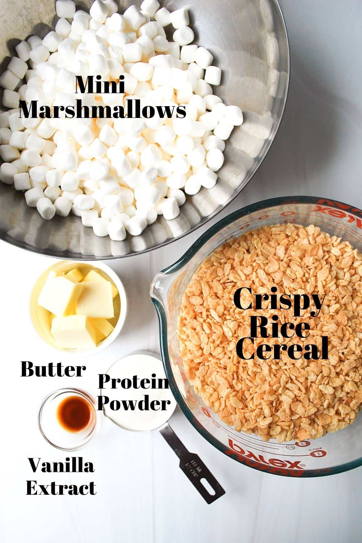 ingredients for protein rice crispy treats measured out on a counter and labeled