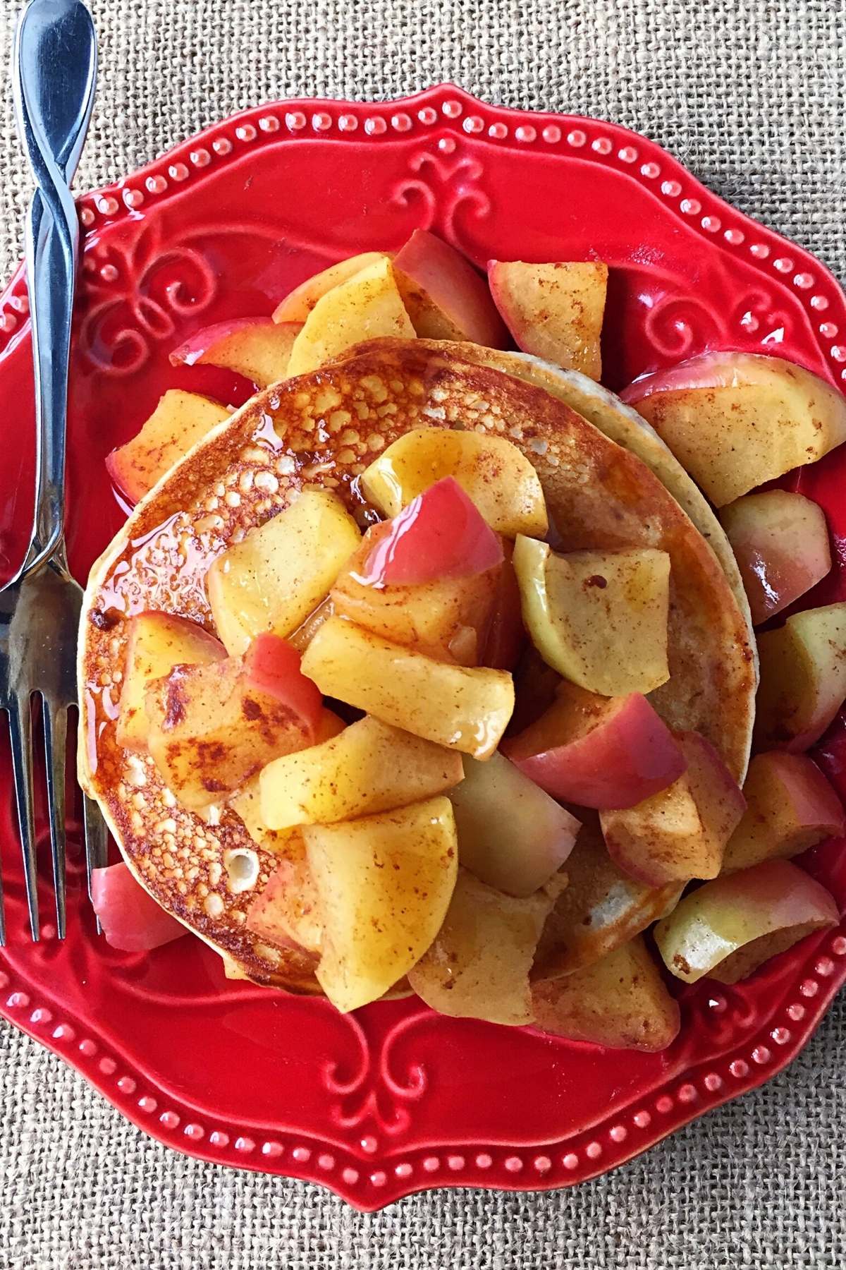 Overhead photo of a plate of protein pancakes topped with cooked apples