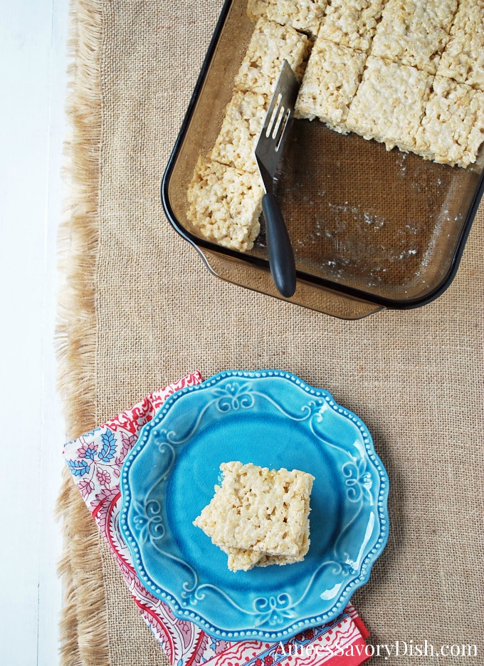 Protein Rice Crispy Treat Bars in pan with a plate of bars