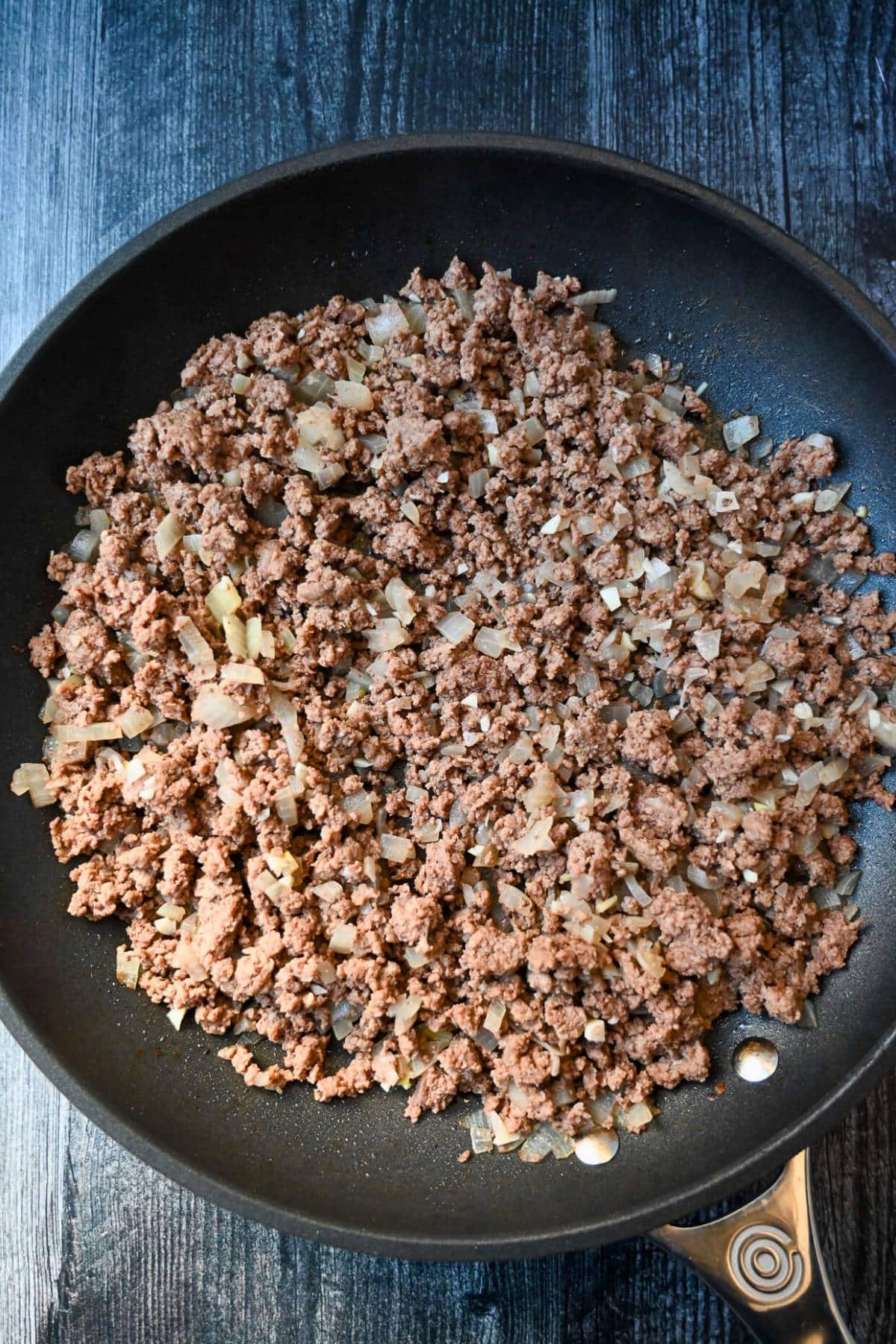 sauteed ground beef with onions and garlic in a skillet