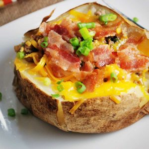 loaded potato with all the toppings on a plate