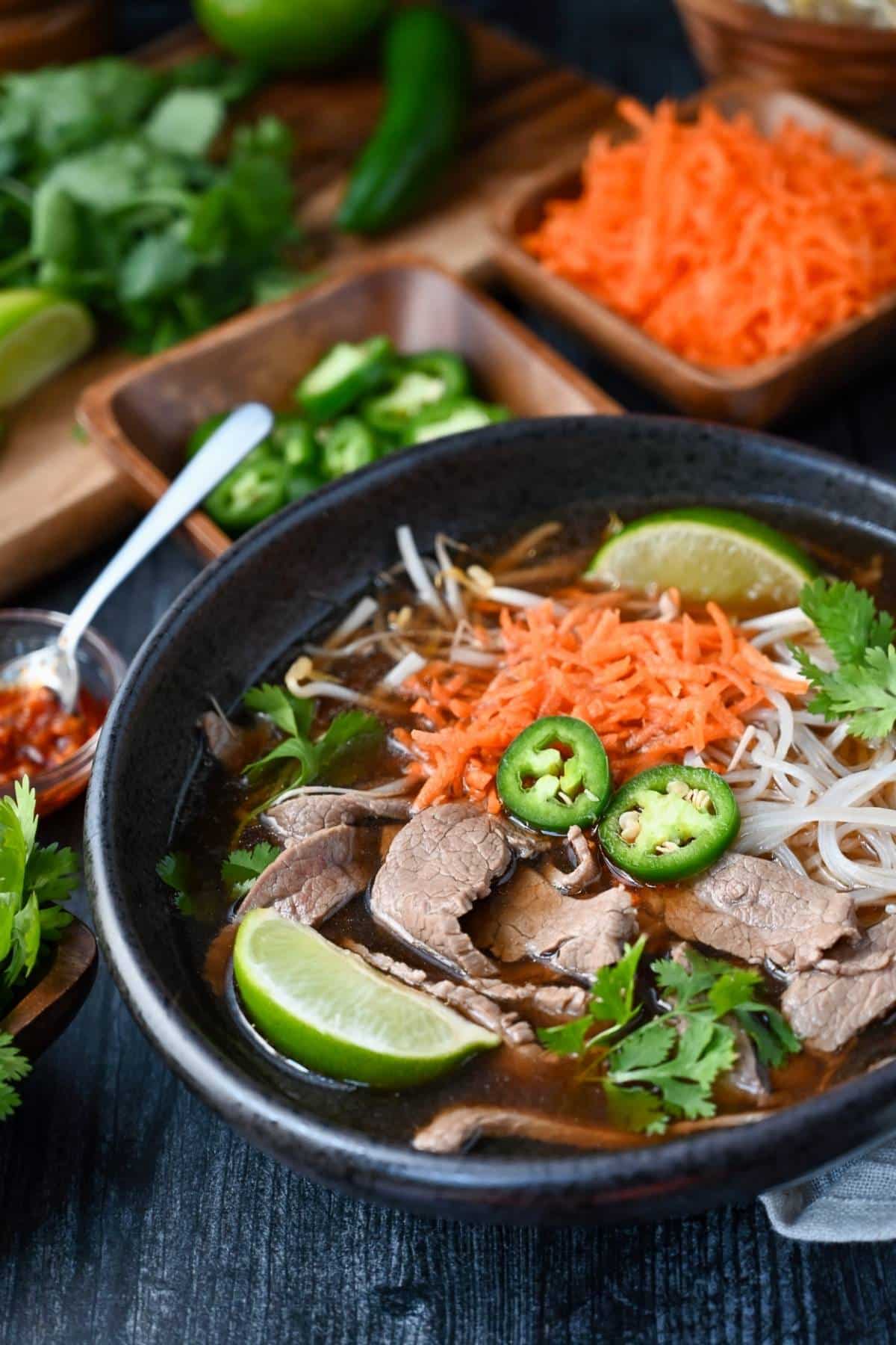 Make your own DIY beef pho bowls with a simple and delicious flank steak pho recipe!  Tender flank steak is the star of this nutritious one-dish meal. via @Ameessavorydish