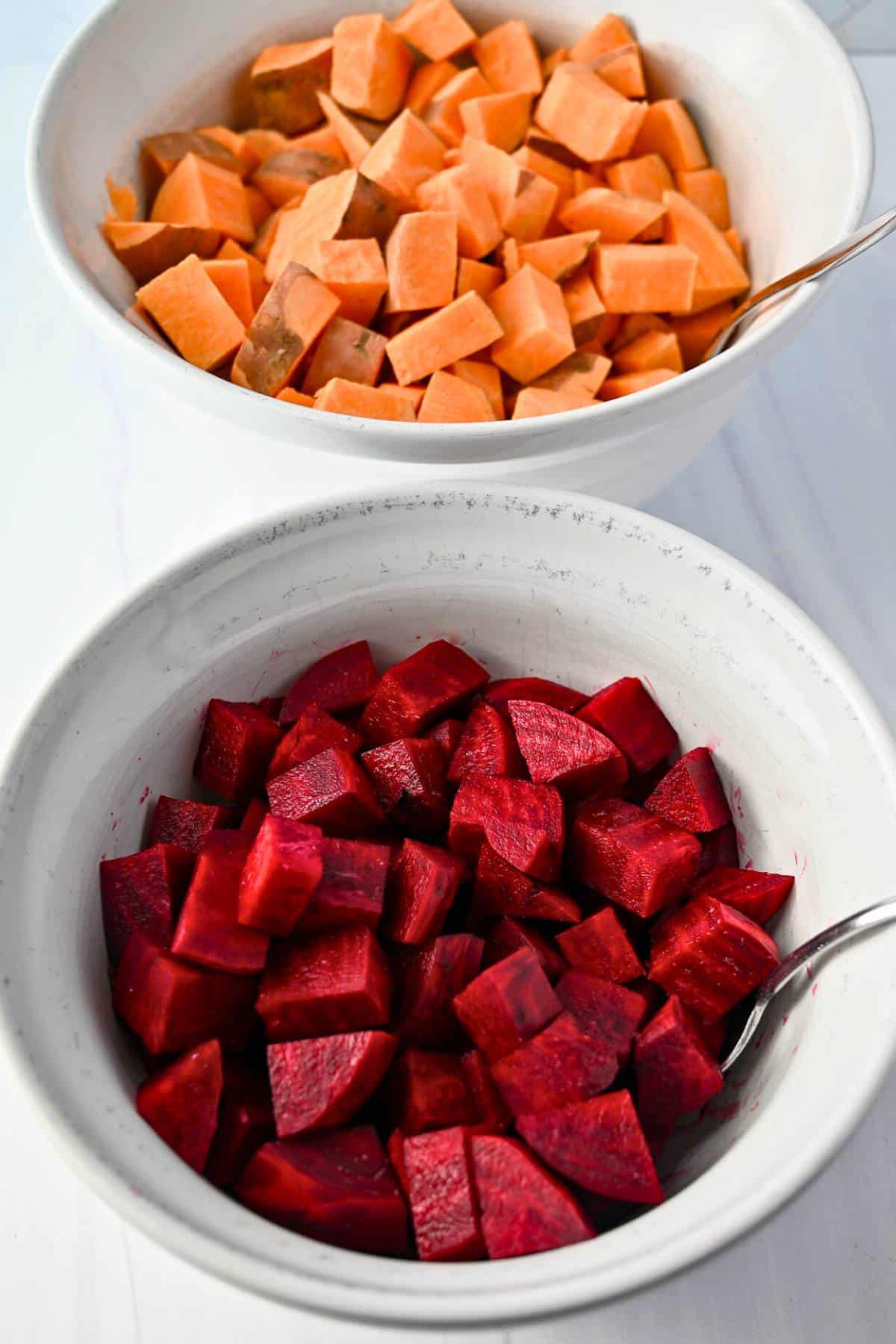 chopped beets and sweet potatoes in separate bowls