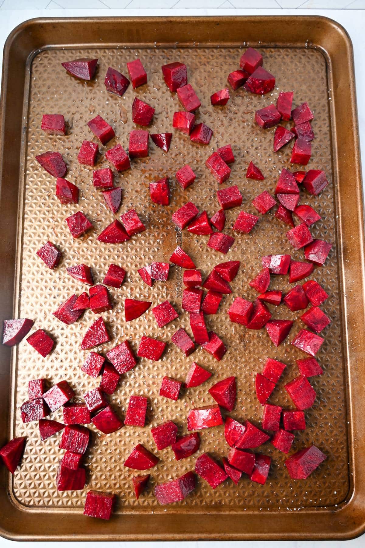 raw cubed beets on a baking sheet