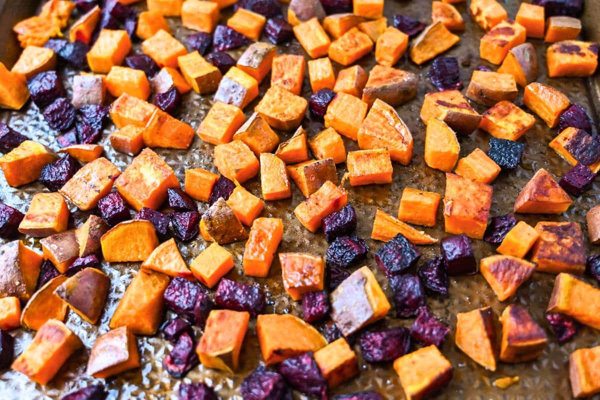 roasted beets and sweet potatoes on a sheet pan