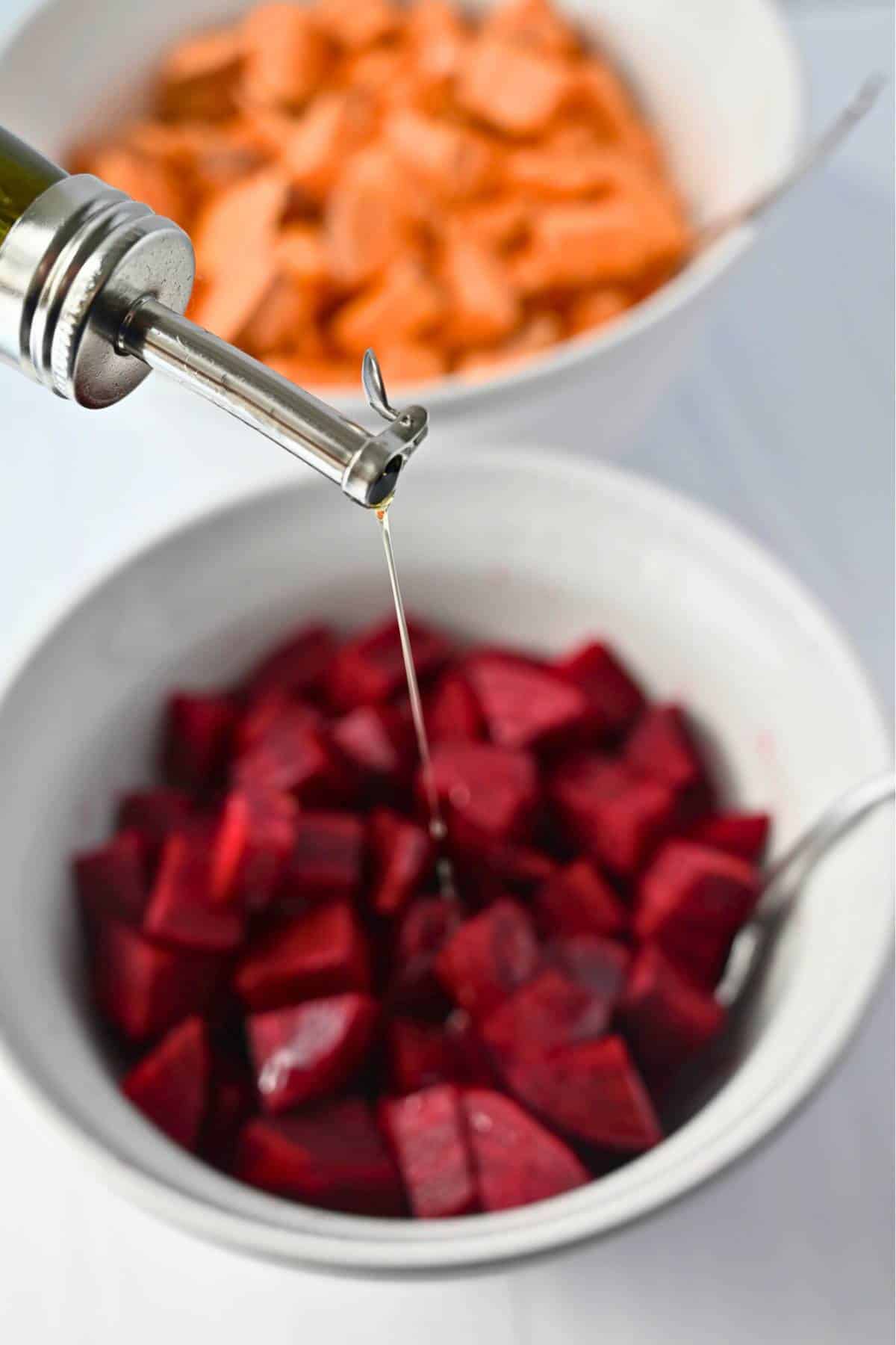 pouring olive oil over beets in a bowl