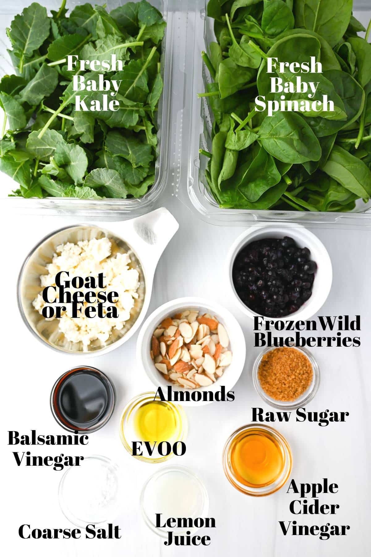 ingredients for kale and spinach salad measured out into containers on a white counter