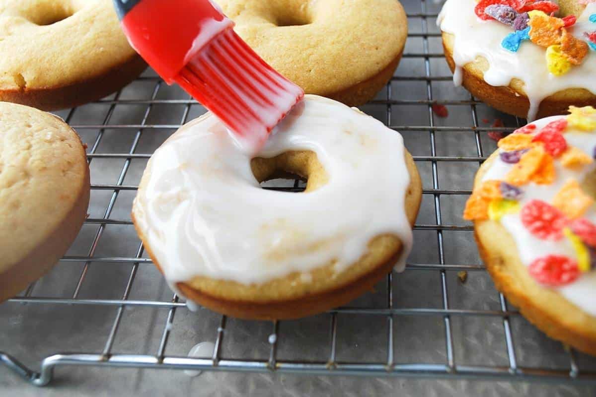 brushing glaze on a protein donut