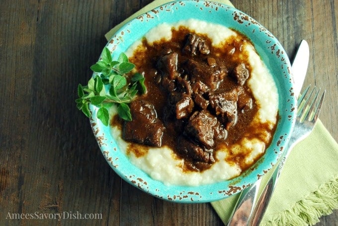 Mediterranean beef over mashed cauliflower in a blue bowl