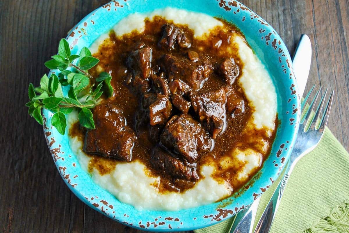 cooked bowl of Mediterranean beef over mashed cauliflower with juices