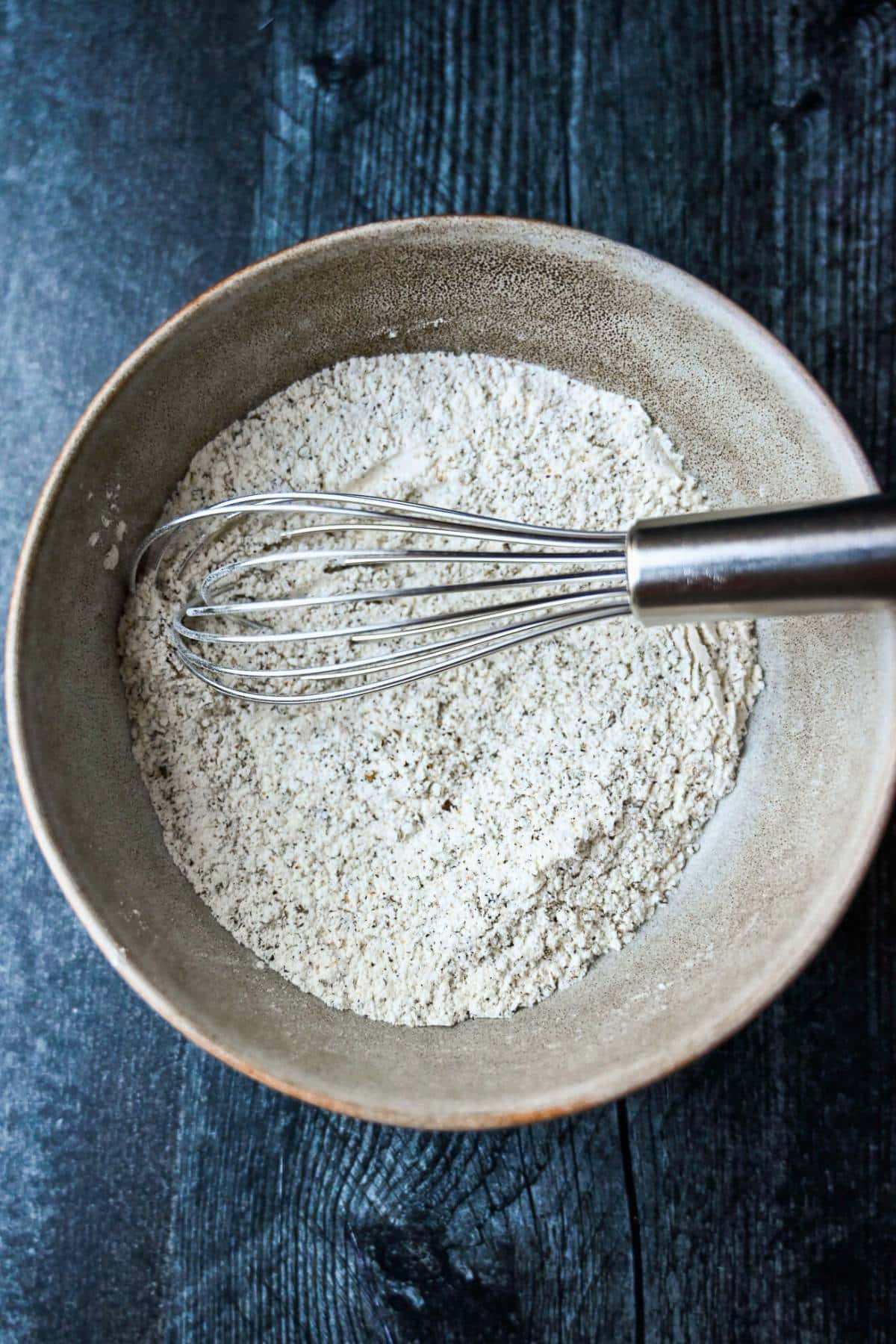 flour and seasonings mixed in a bowl with a whisk