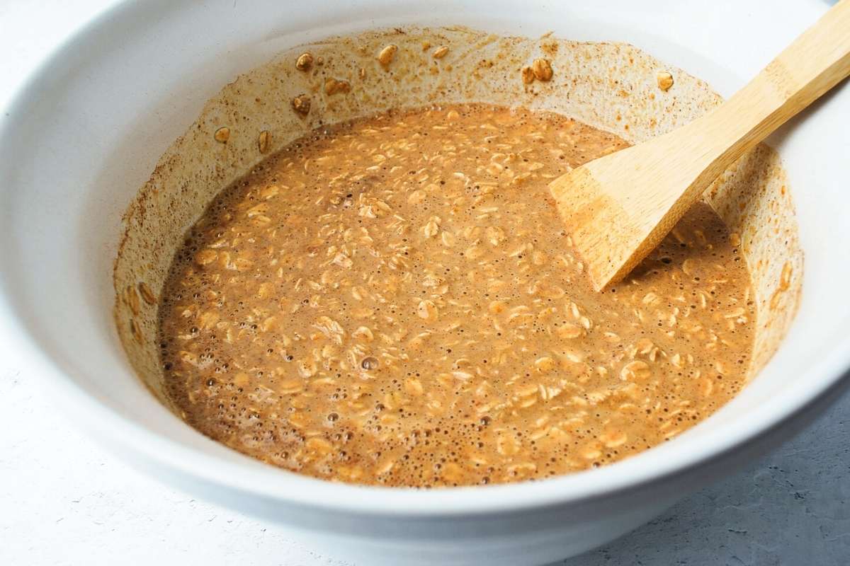 batter for pumpkin baked oatmeal mixed in a bowl with a spoon