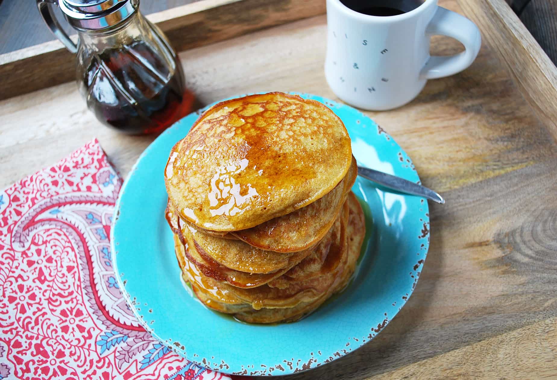 sweet potato pancakes with syrup on a blue plate