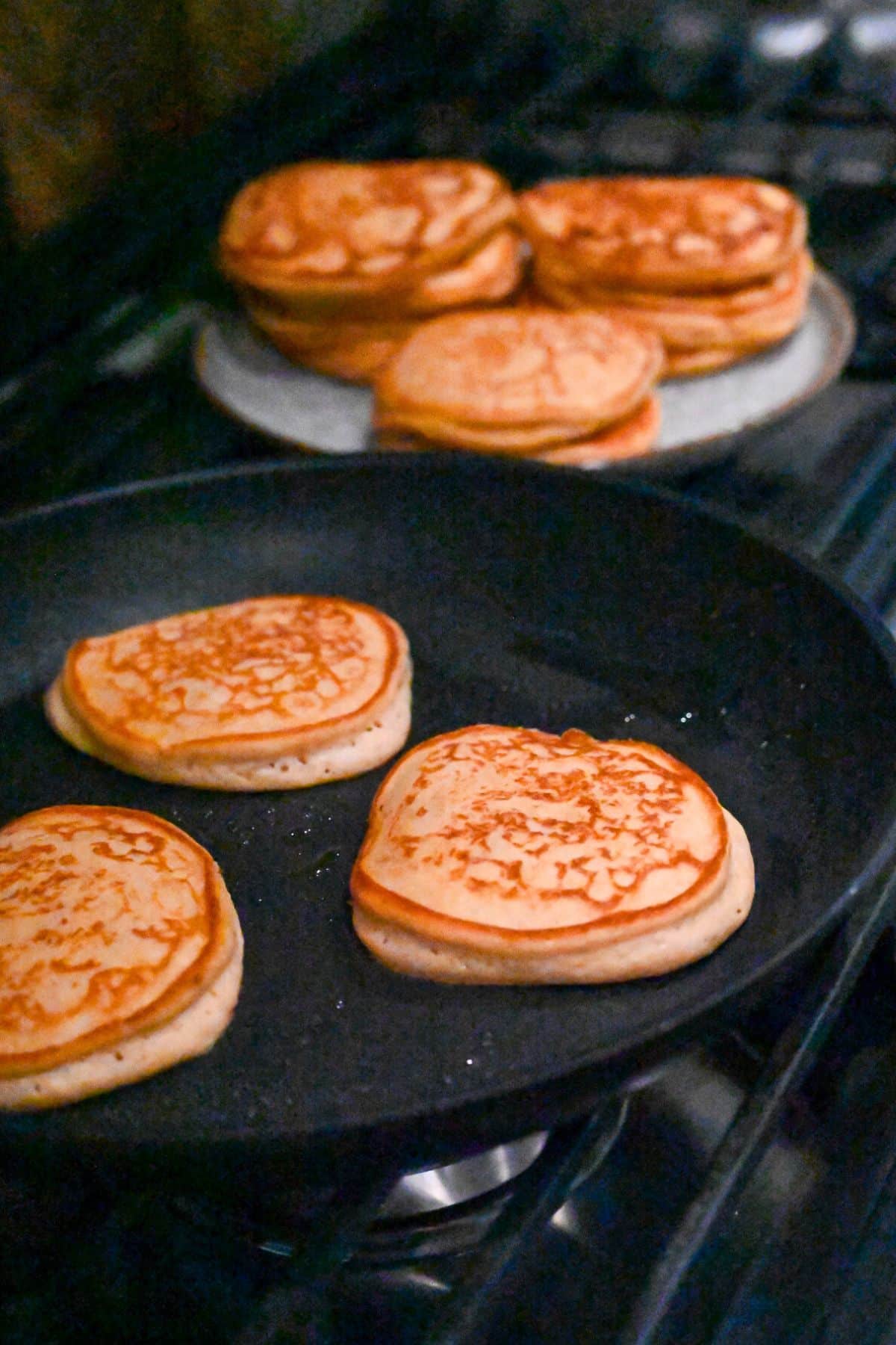 sweet potato pancakes cooking in a skillet