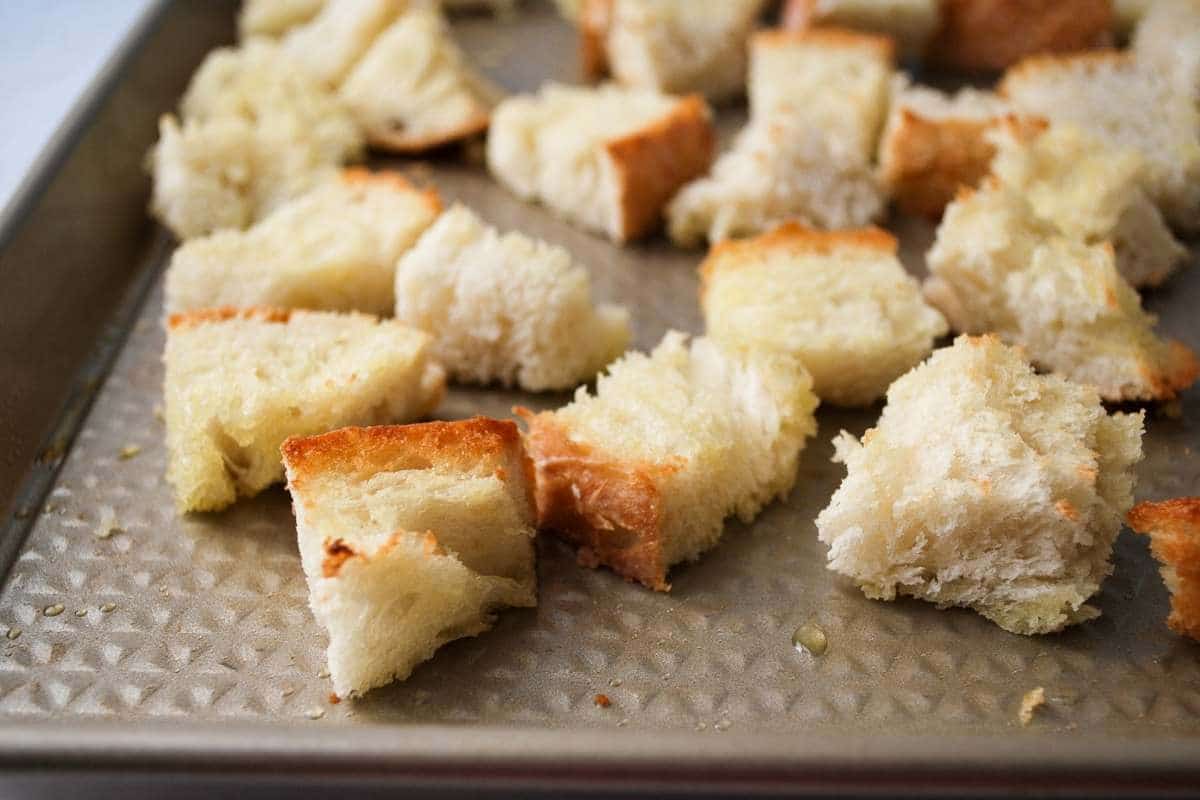 bread cubes toasted on a baking sheet