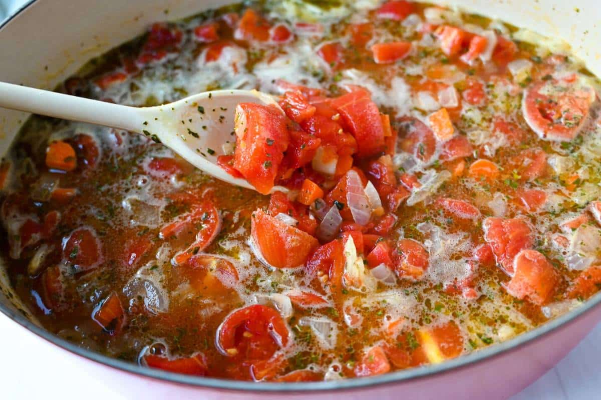 tomato basil soup ingredients in a dutch oven ready to simmer