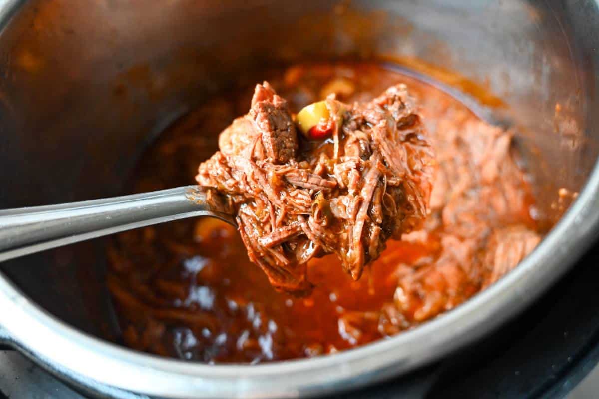 a spoonful of cuban beef in an instant pot