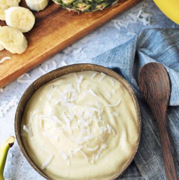 Tropical ice cream in a coconut bowl with shredded coconut on top