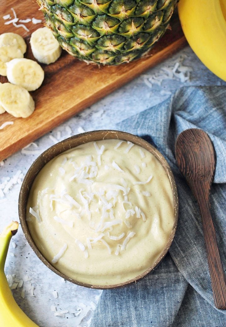 bowl of tropical ice cream with bananas and pineapple 