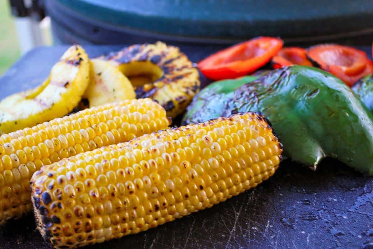 grilled vegetables next to a big green egg