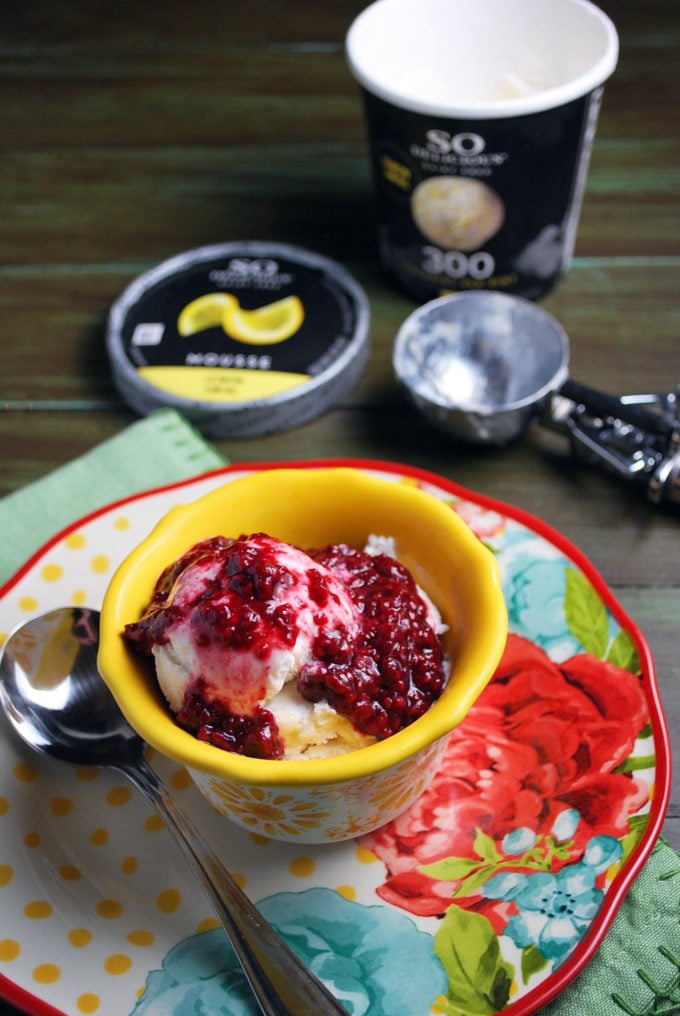 lemon mousse topped with raspberry compote in a colorful bowl