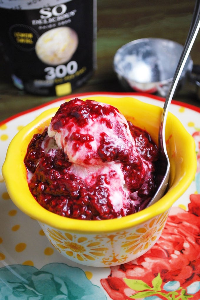 Close up of a bowl of frozen lemon mousse topped with raspberry compote